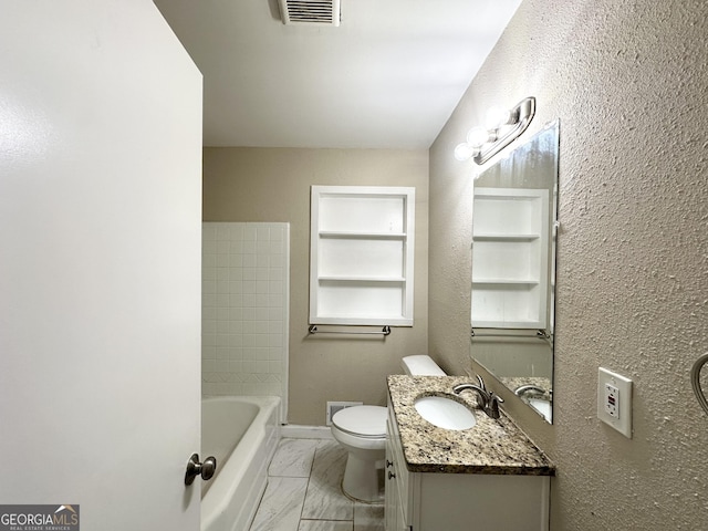 bathroom featuring built in shelves, vanity, and toilet