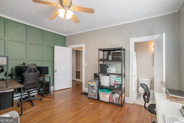 office space featuring ceiling fan, light wood-type flooring, and ornamental molding