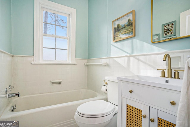 bathroom with vanity, toilet, and a bath