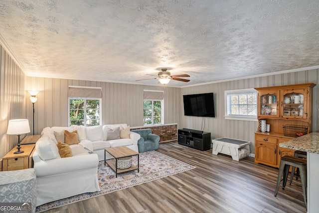 living room featuring ceiling fan, crown molding, and dark hardwood / wood-style floors