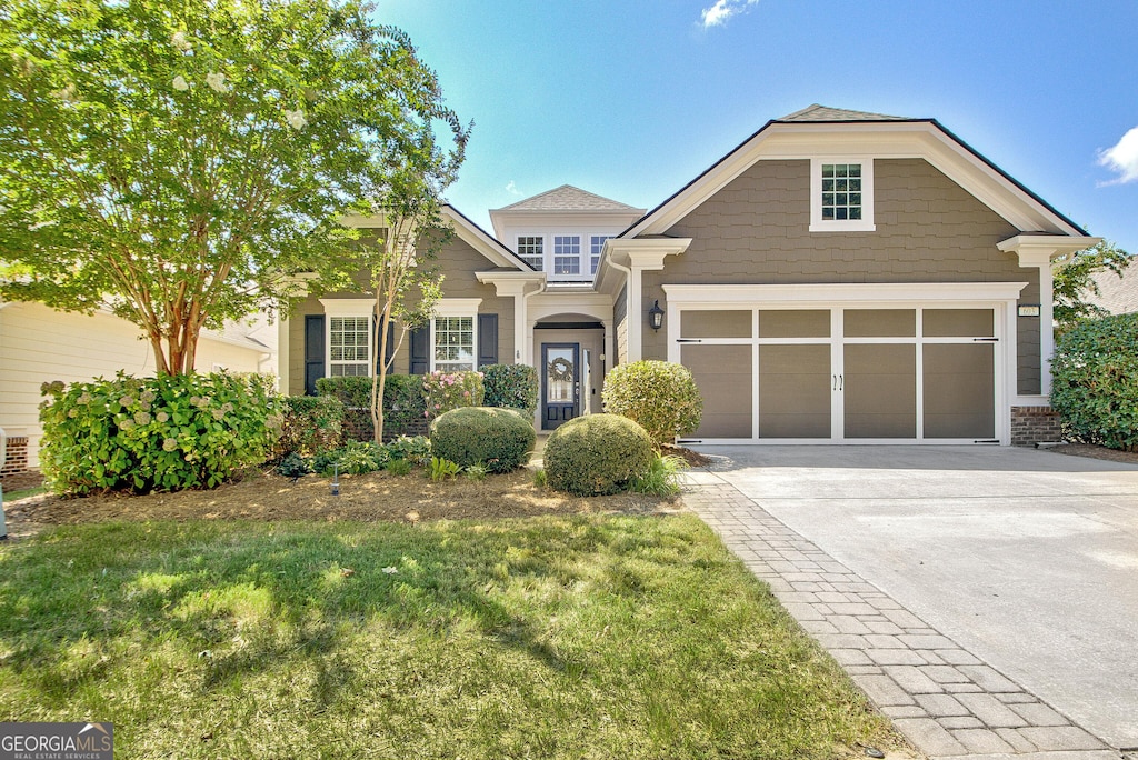 view of front facade with a garage and a front lawn