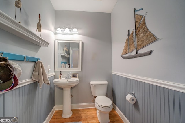 bathroom with hardwood / wood-style floors, toilet, and sink