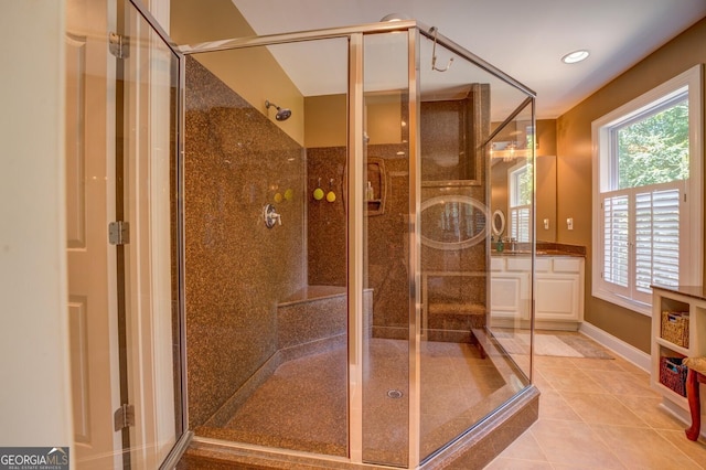 bathroom with tile patterned floors, vanity, and a shower with shower door