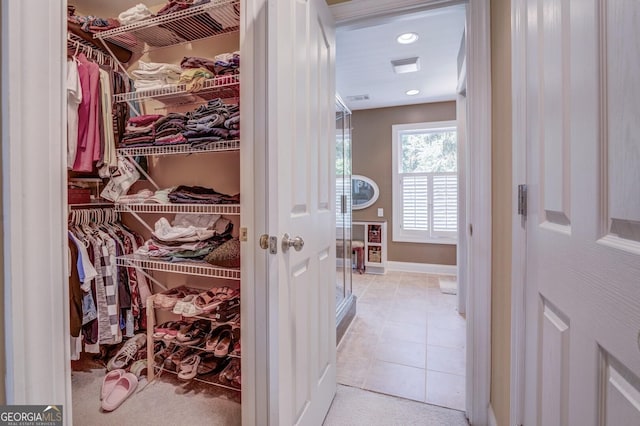 walk in closet with light tile patterned flooring