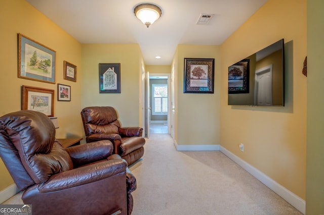 sitting room featuring light carpet