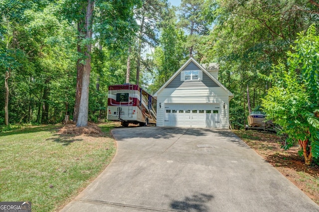 view of front facade with a front yard, an outdoor structure, and a garage