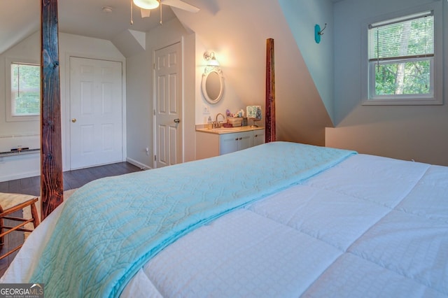 bedroom featuring ceiling fan, dark hardwood / wood-style floors, and vaulted ceiling