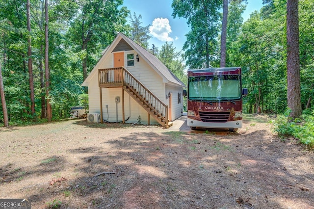 rear view of property featuring ac unit