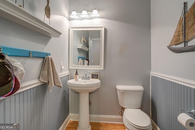 bathroom with hardwood / wood-style flooring, sink, and toilet