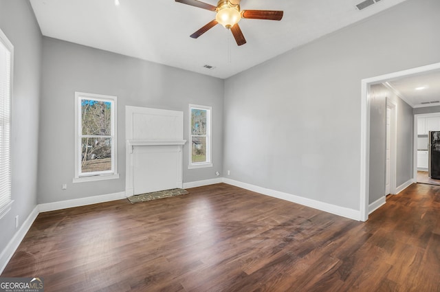 unfurnished living room featuring dark hardwood / wood-style floors, a wealth of natural light, and ceiling fan