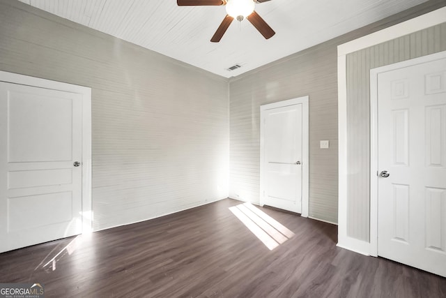 unfurnished bedroom featuring ceiling fan and dark wood-type flooring