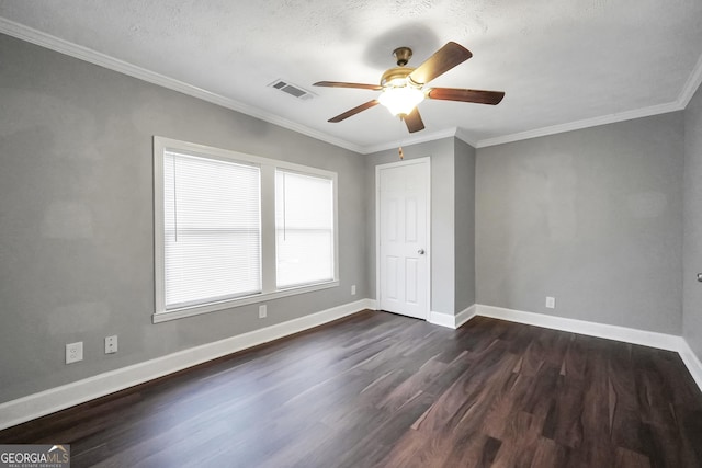 unfurnished bedroom featuring ceiling fan, dark hardwood / wood-style flooring, ornamental molding, and a textured ceiling