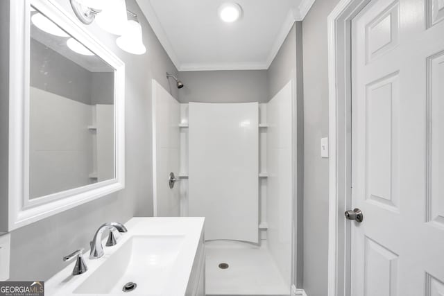 bathroom featuring crown molding, sink, and walk in shower