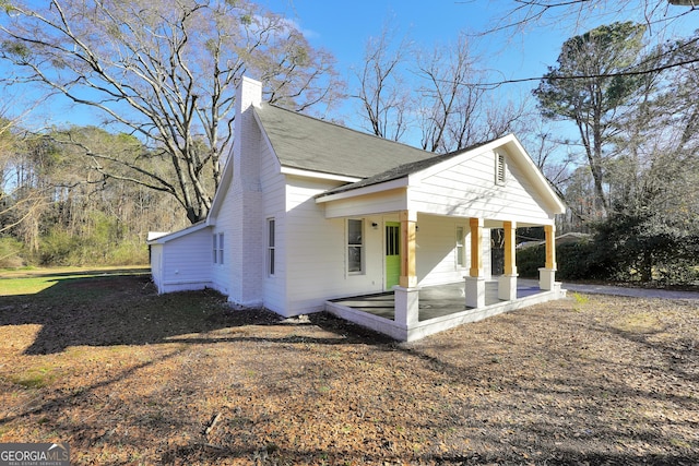 view of side of home with a porch