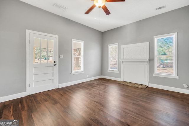 entryway featuring plenty of natural light, ceiling fan, and dark hardwood / wood-style flooring