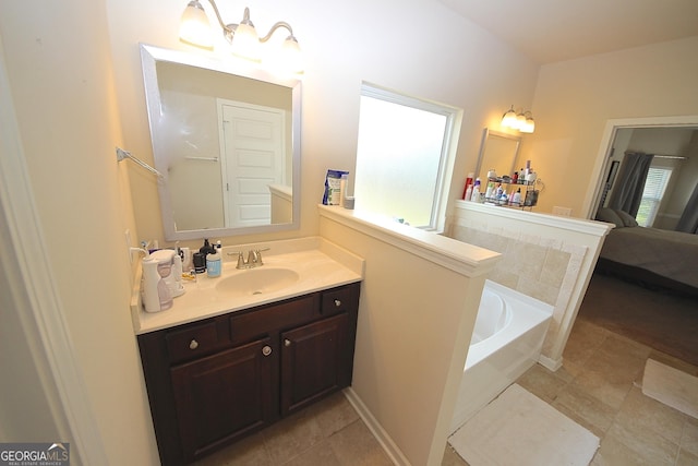 bathroom with a bathtub, tile patterned flooring, and vanity