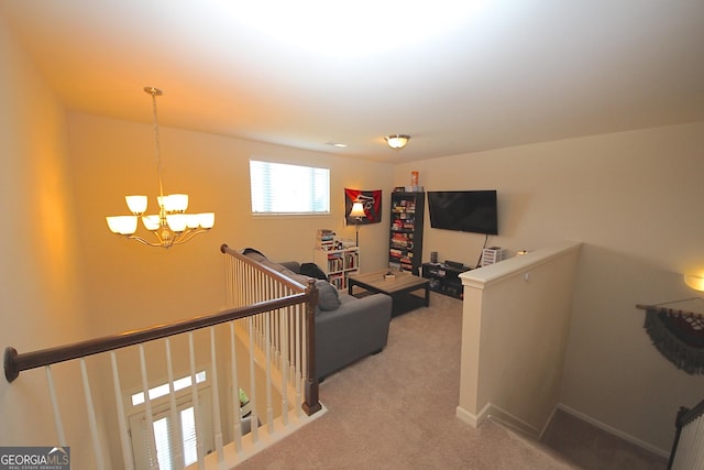 carpeted living room with an inviting chandelier