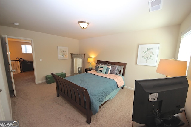 bedroom with light colored carpet