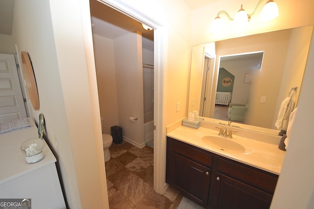 bathroom with vanity, toilet, and radiator