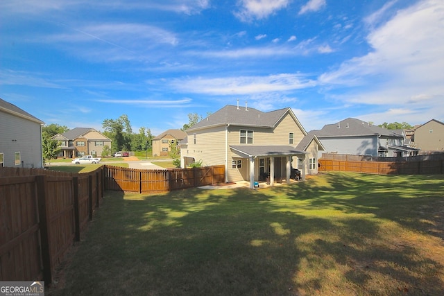 rear view of property with a yard