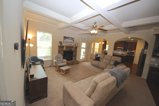 carpeted living room featuring beamed ceiling, a fireplace, and coffered ceiling