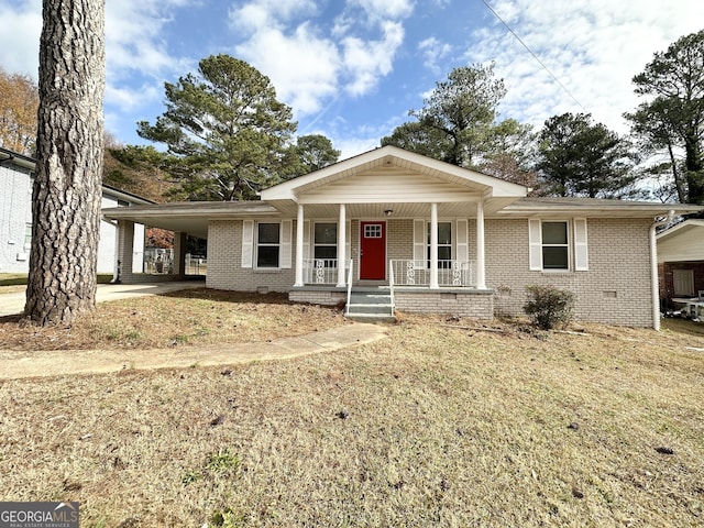 view of front of home with covered porch and a carport