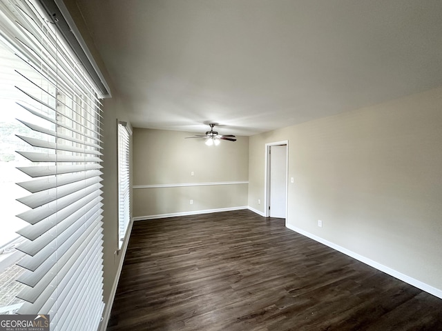 unfurnished room featuring ceiling fan and dark hardwood / wood-style flooring