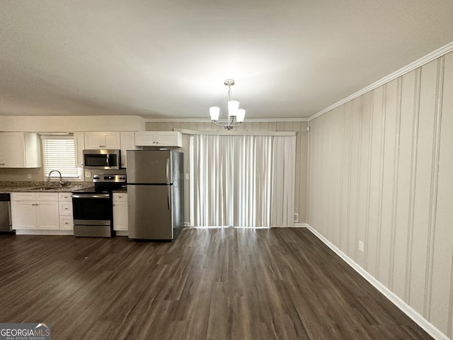 kitchen featuring white cabinetry, sink, a chandelier, decorative light fixtures, and appliances with stainless steel finishes