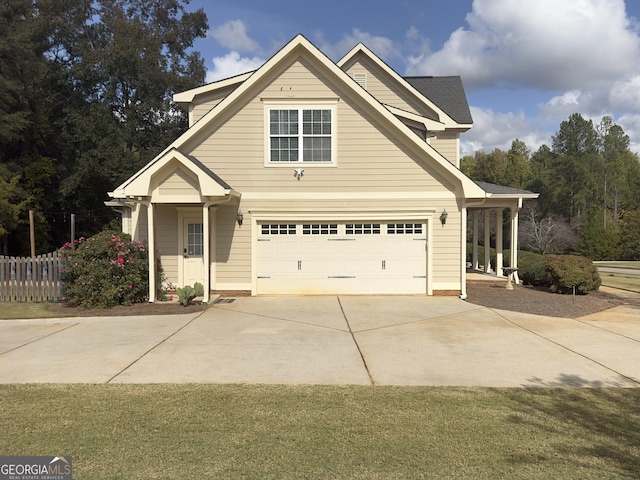 view of front of property featuring a garage and a front lawn