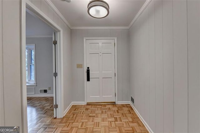 interior space with light parquet floors and crown molding