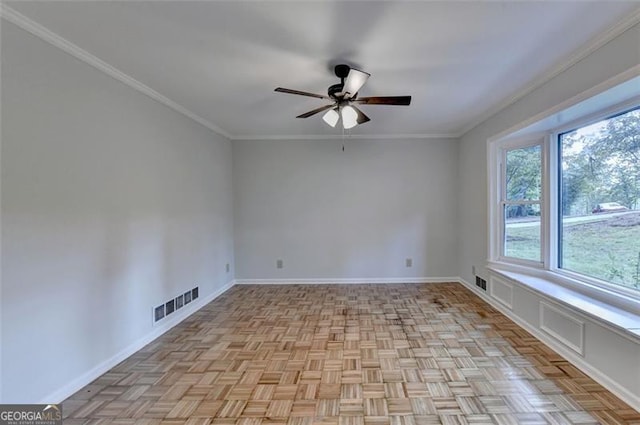 spare room featuring ceiling fan, light parquet flooring, and ornamental molding