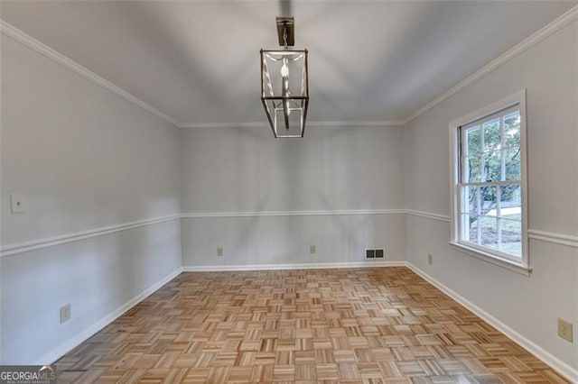 unfurnished dining area featuring light parquet floors, ornamental molding, and an inviting chandelier