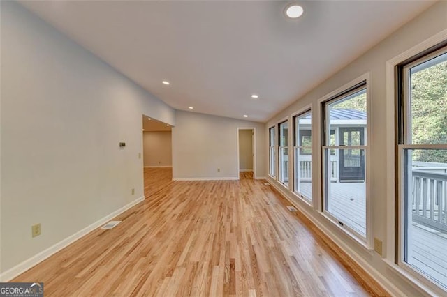 unfurnished room with light wood-type flooring