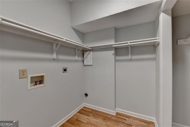 laundry room featuring hookup for an electric dryer, hardwood / wood-style floors, and hookup for a washing machine