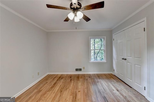 unfurnished room featuring crown molding, ceiling fan, and light wood-type flooring