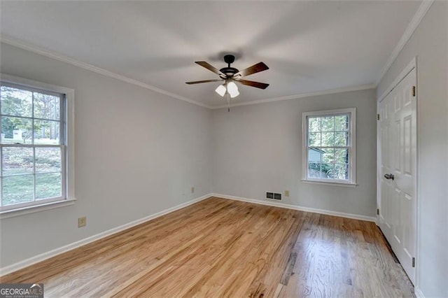 unfurnished room with crown molding, light hardwood / wood-style flooring, ceiling fan, and plenty of natural light