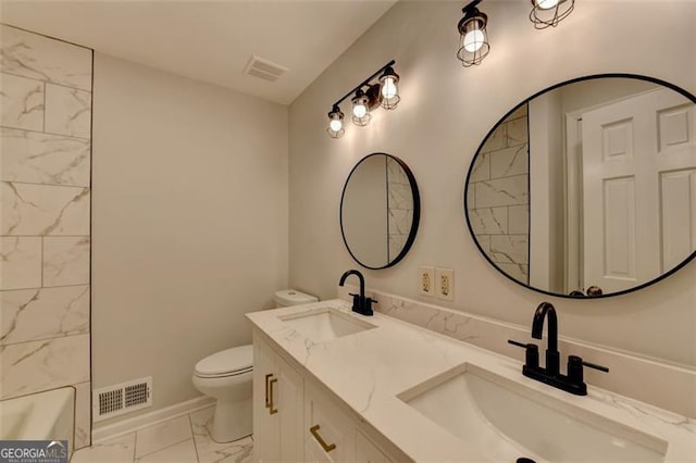 bathroom featuring vanity and toilet