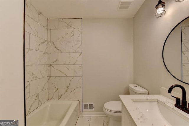 full bathroom featuring tiled shower / bath, vanity, and toilet