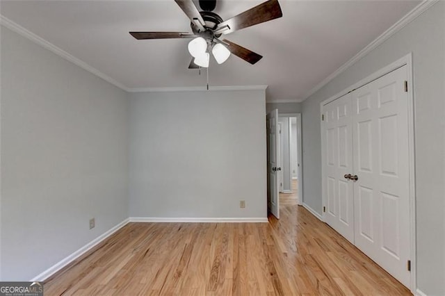 unfurnished bedroom with a closet, ceiling fan, crown molding, and light wood-type flooring