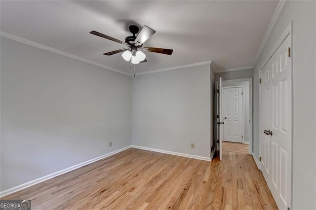 unfurnished bedroom featuring ceiling fan, light wood-type flooring, and ornamental molding