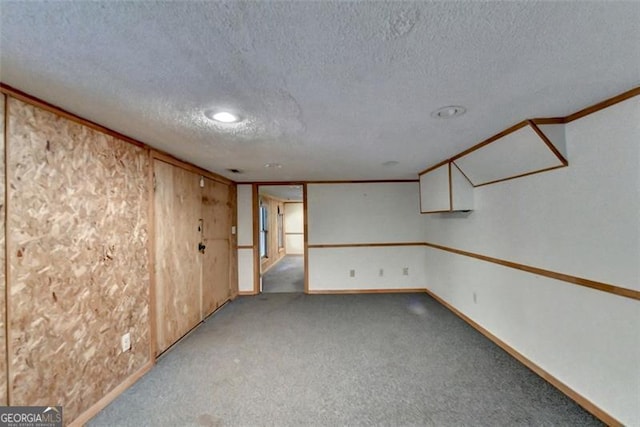 empty room featuring ornamental molding, a textured ceiling, and light carpet