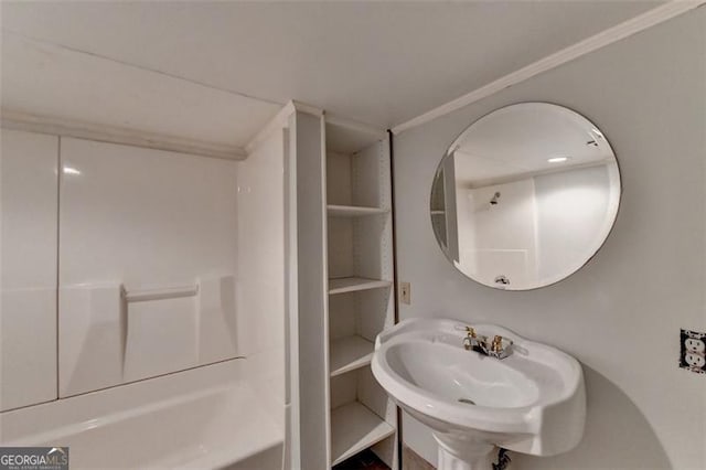 bathroom with shower / tub combination, crown molding, and sink