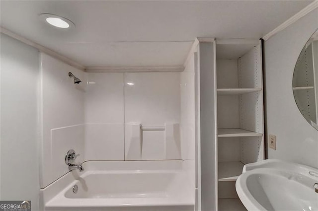 bathroom featuring sink, ornamental molding, and washtub / shower combination