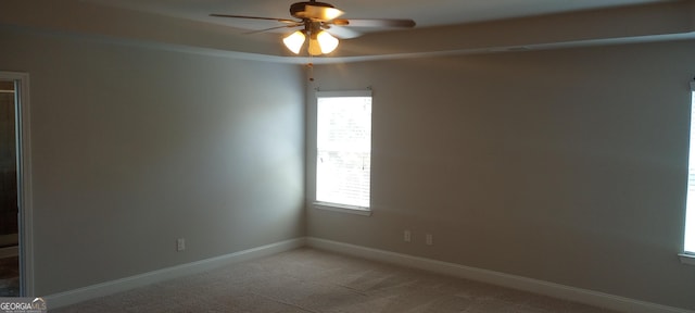 spare room with carpet floors, ceiling fan, and a healthy amount of sunlight