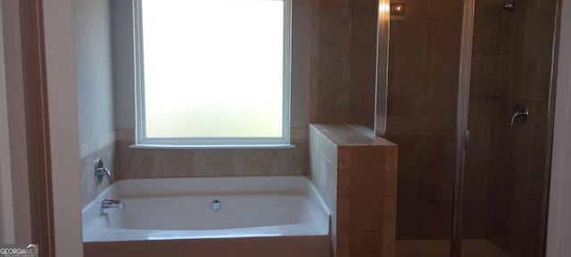 bathroom featuring separate shower and tub