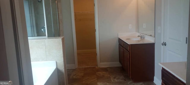 bathroom with vanity and a tub