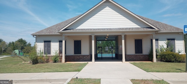 view of front of property with a front yard and a porch