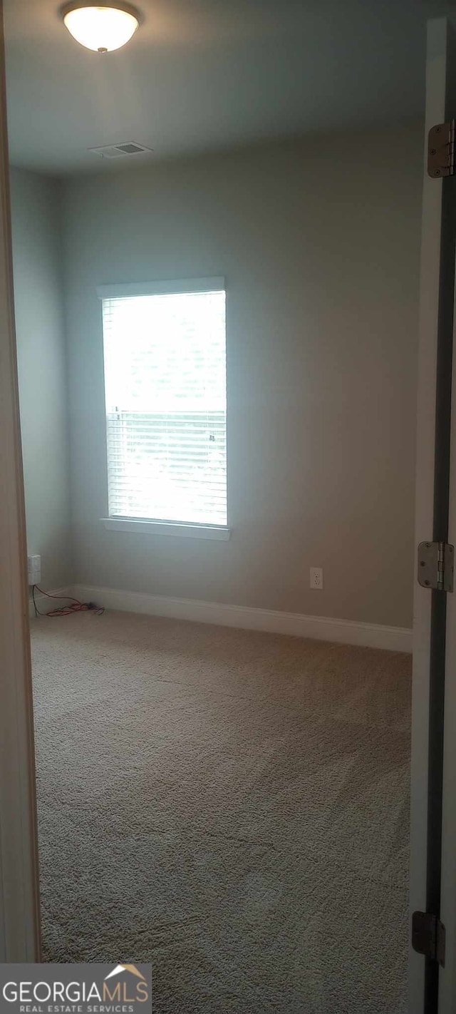 spare room featuring carpet flooring