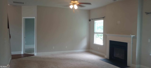 unfurnished living room featuring ceiling fan and light colored carpet