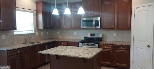 kitchen with decorative backsplash, stainless steel appliances, light stone counters, and sink